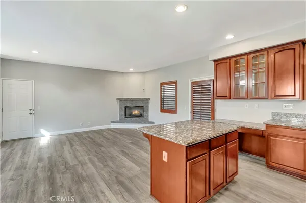 a kitchen with stainless steel appliances granite countertop a sink dishwasher stove and wooden floor