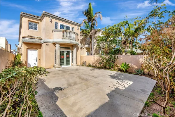 a view of a white house with a yard