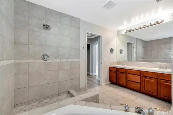a bathroom with double vanity and a bathtub