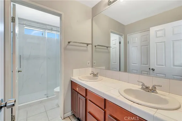 a bathroom with a sink double vanity and shower