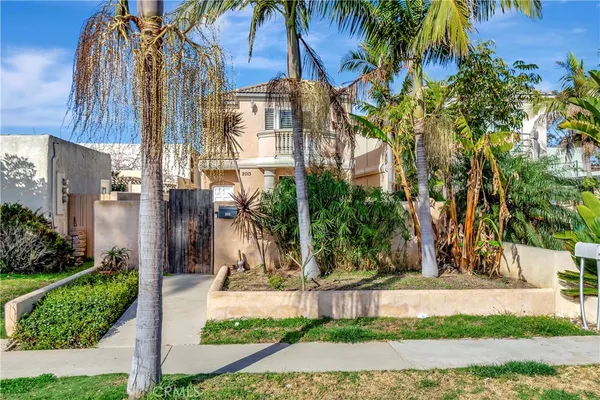 a front view of a residential apartment building with a yard