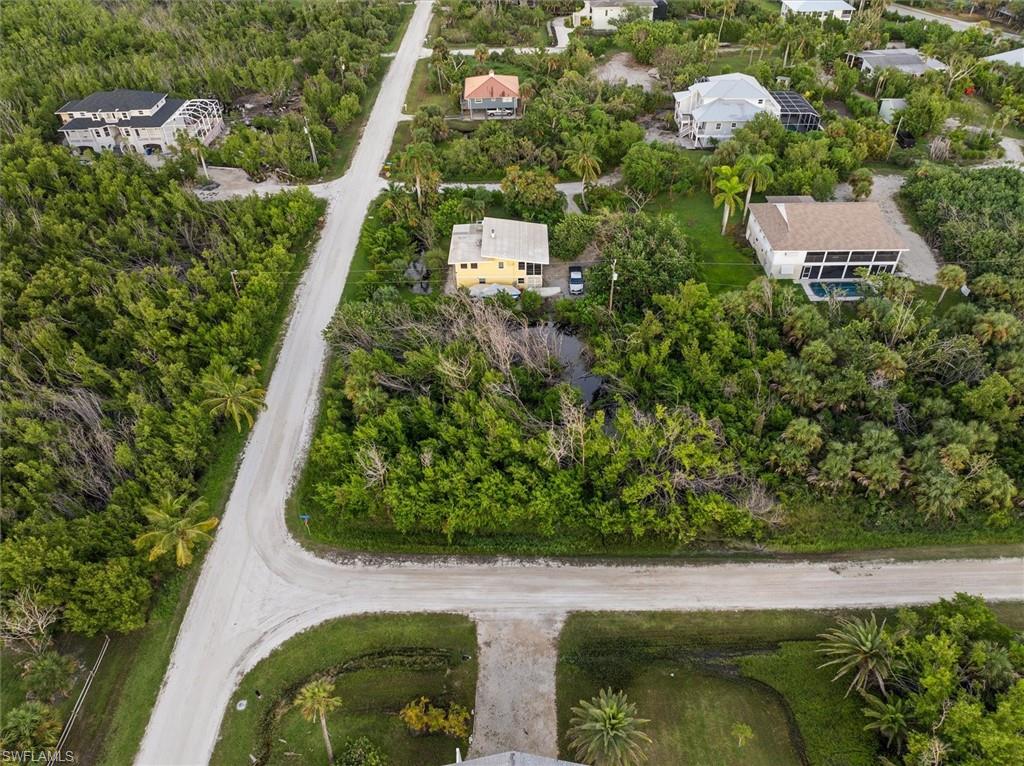 486 Ponce De Leon Road Sanibel, FL 33957 - Photo 8 of 23 an aerial view of residential house with outdoor space and trees all around