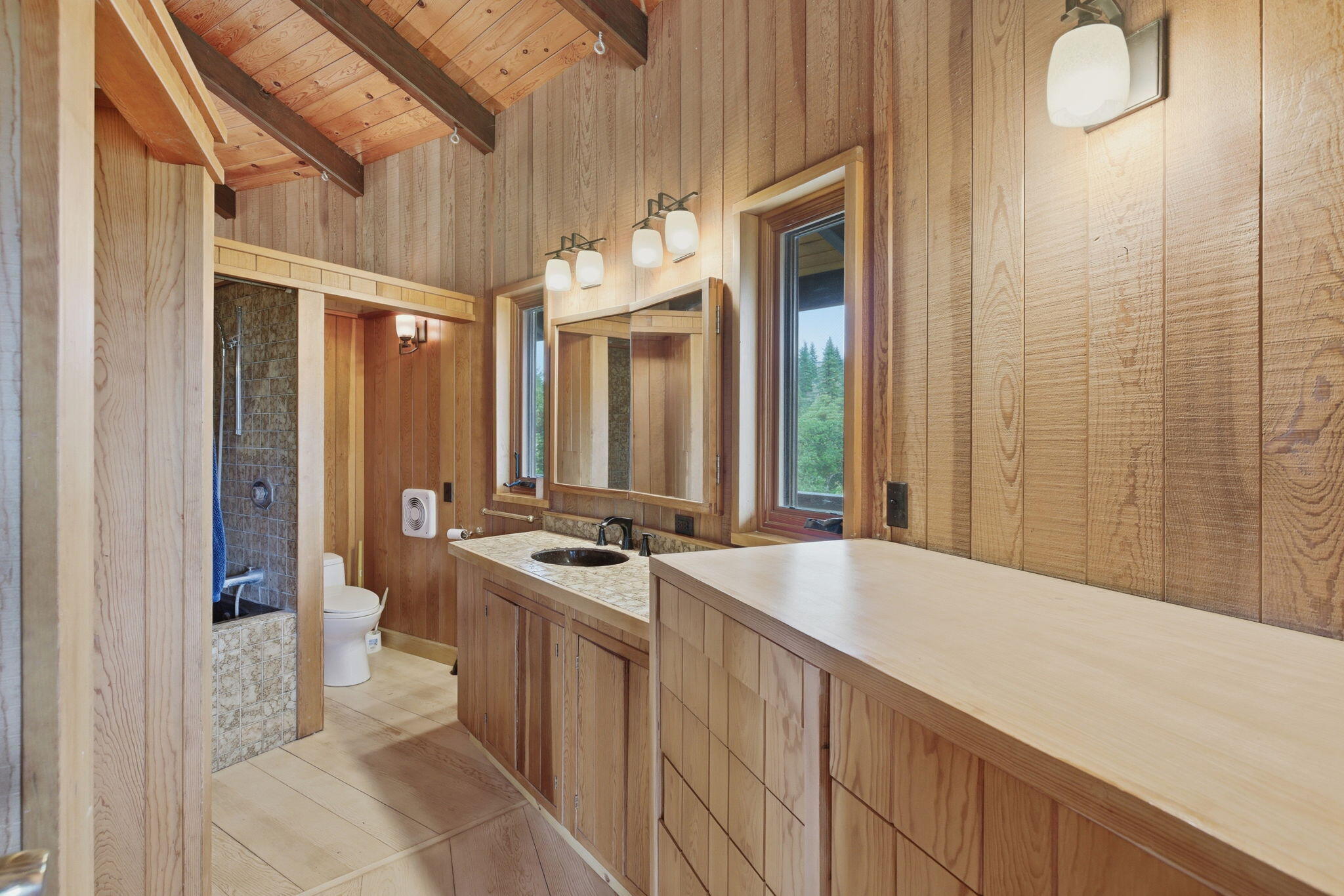 9595 Sterling Creek Road Jacksonville, OR 97530 - Photo 19 of 76 a spacious bathroom with a double vanity sink a toilet a mirror and shower