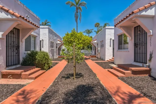 a view of a house with potted plants