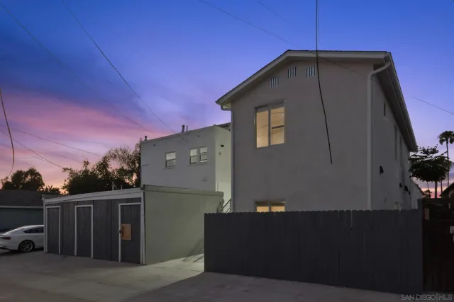 a front view of a house with wooden fence