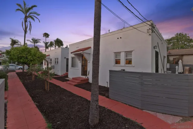 a view of a house with backyard and sitting area