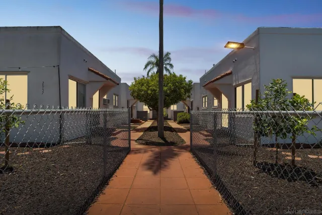 a view of a house with backyard and sitting area