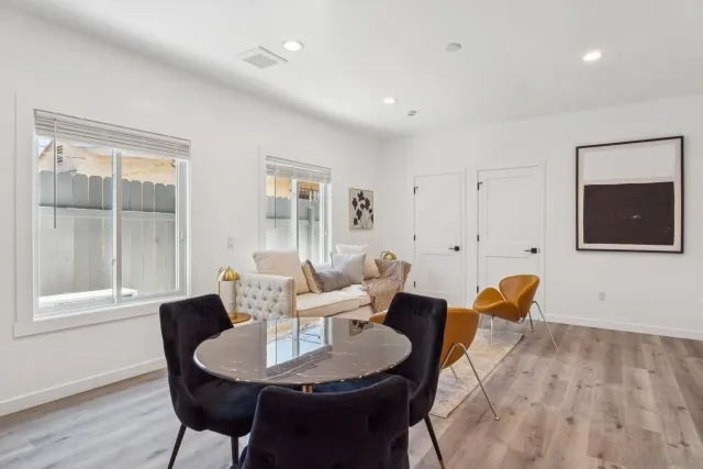 a dining room with furniture and wooden floor