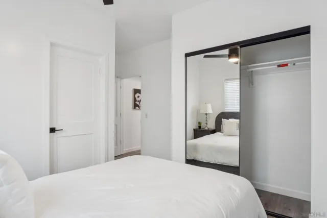 a bedroom with a bed and a mirror