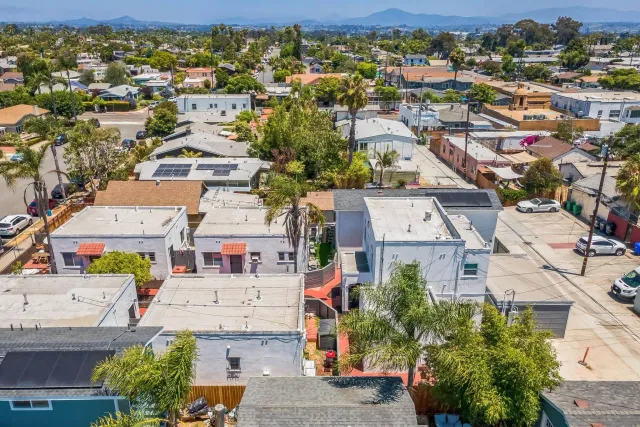 an aerial view of residential houses with outdoor space