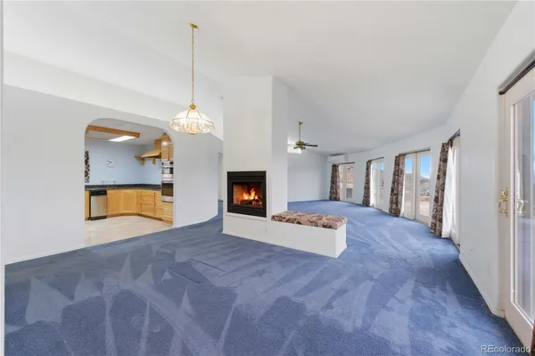 a view of an empty room with a fireplace and a window