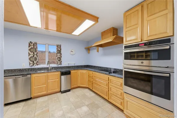 a kitchen with stainless steel appliances granite countertop a stove and a sink