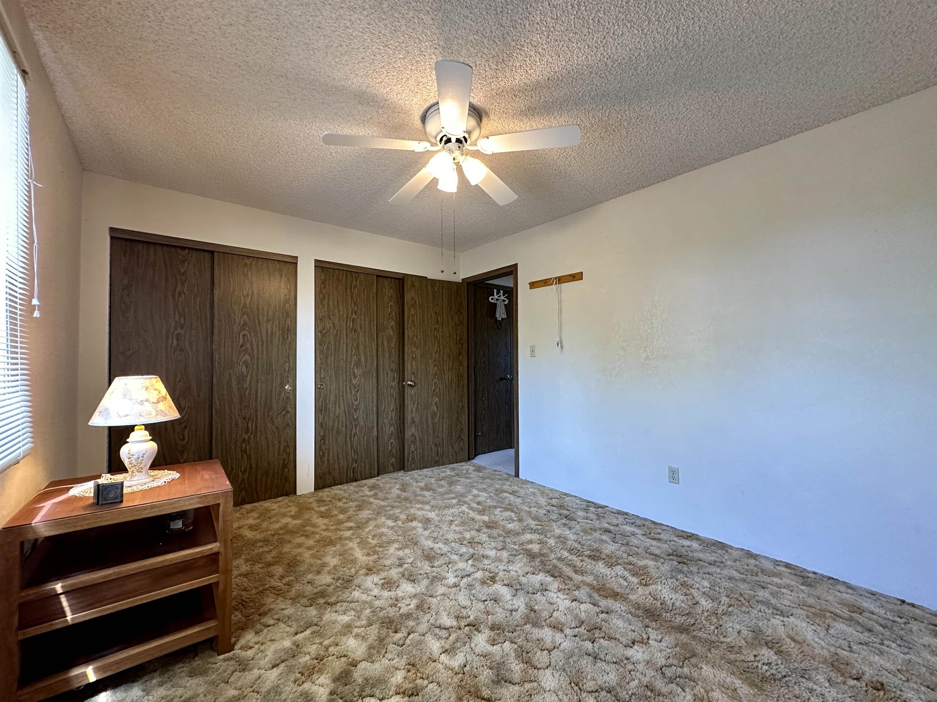 3010 F F 3/4 Road Grand Junction, CO 81504 - Photo 18 of 25 a bedroom with a bed and a chandelier