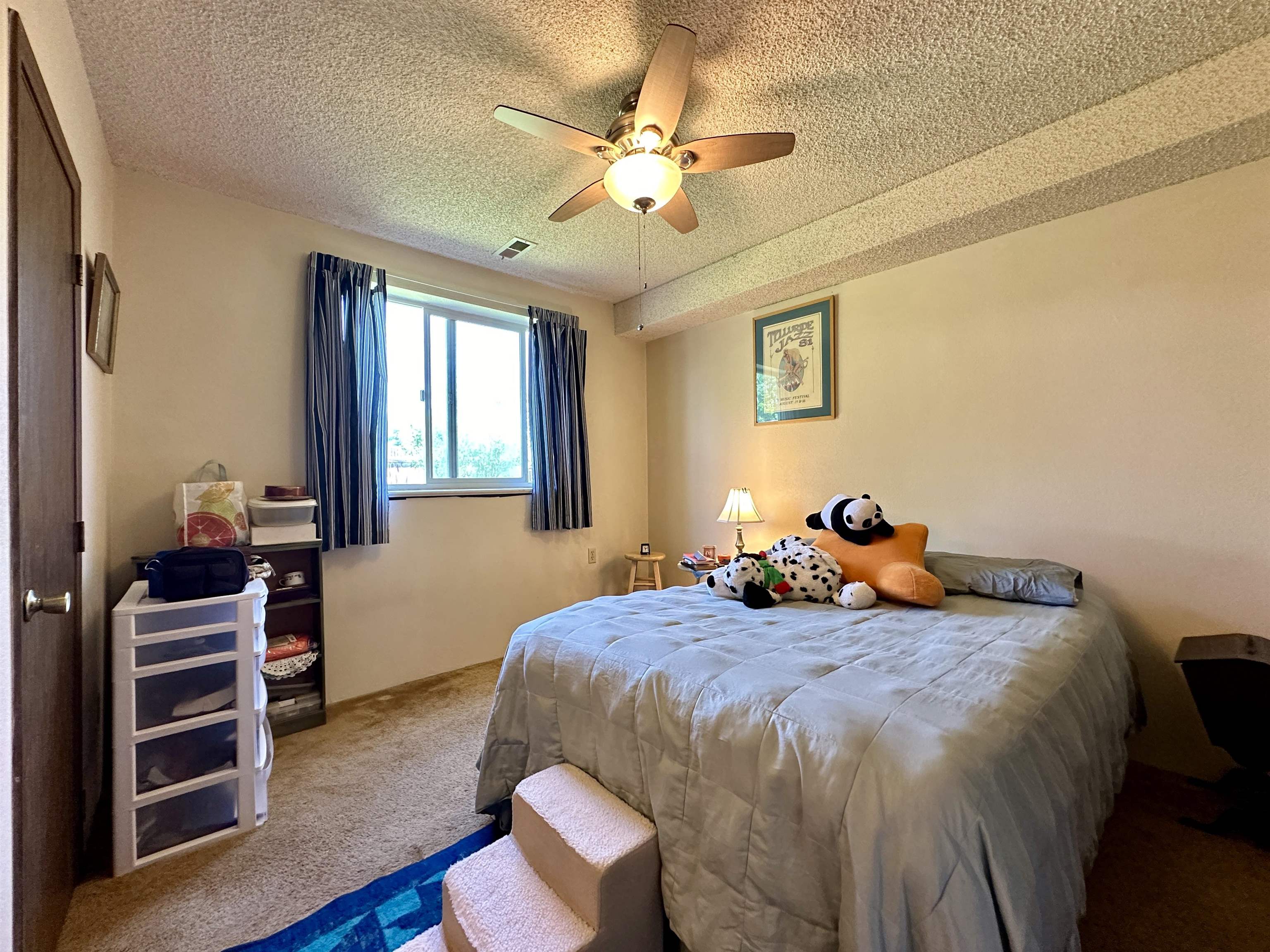 3010 F F 3/4 Road Grand Junction, CO 81504 - Photo 8 of 25 a bedroom with a bed and a chandelier