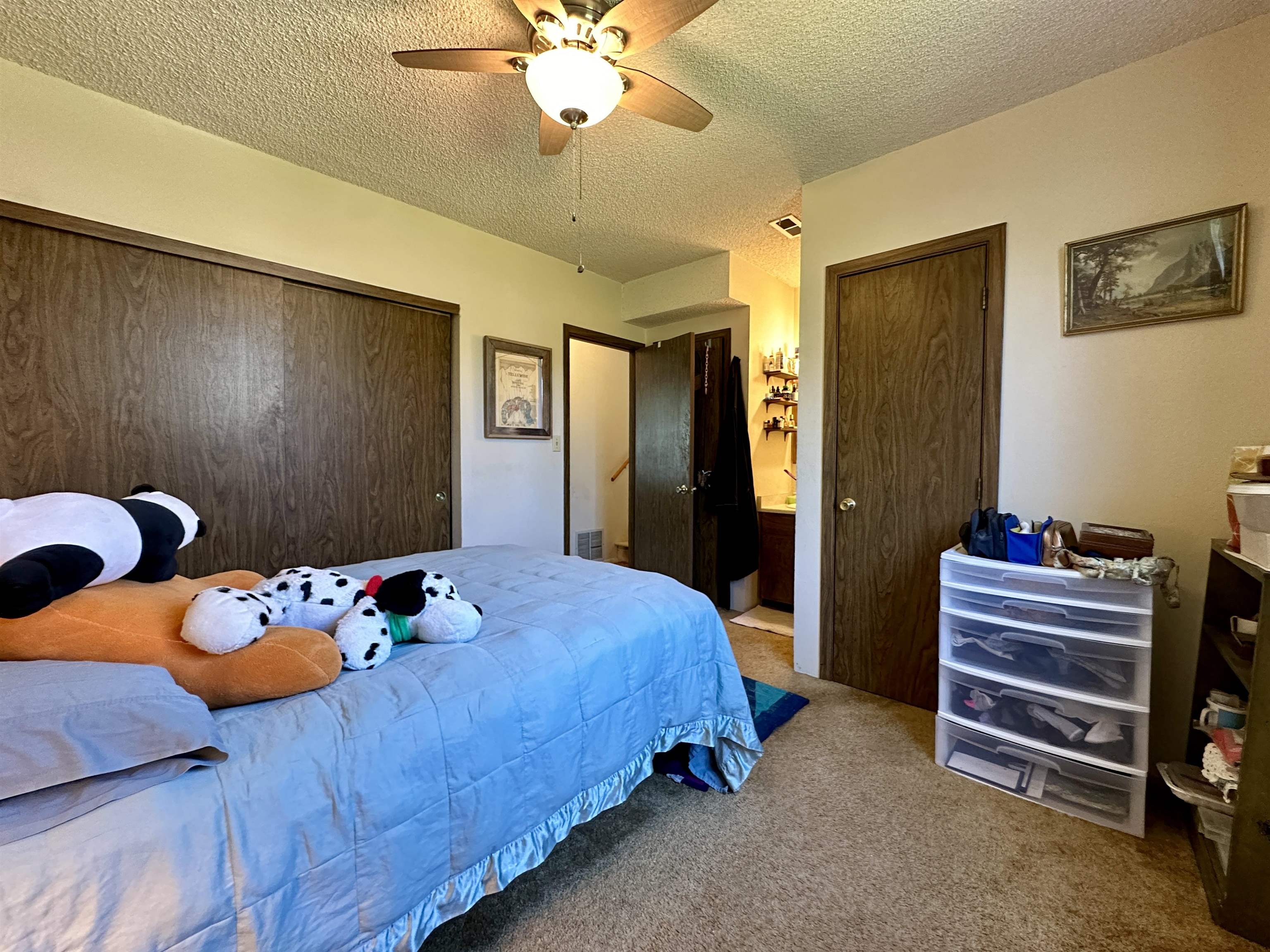 3010 F F 3/4 Road Grand Junction, CO 81504 - Photo 10 of 25 a bedroom with a bed and a chandelier