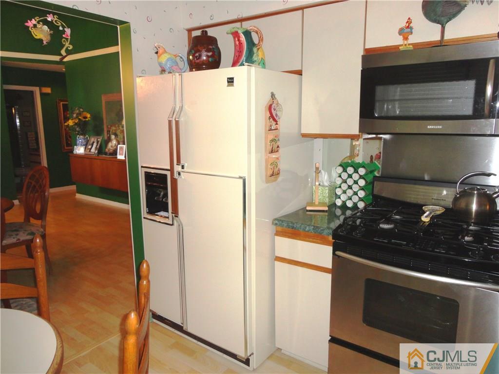 29 Winthrop Road Monroe Township, NJ 08831 - Photo 15 of 25 a white refrigerator freezer and a stove sitting inside of a kitchen