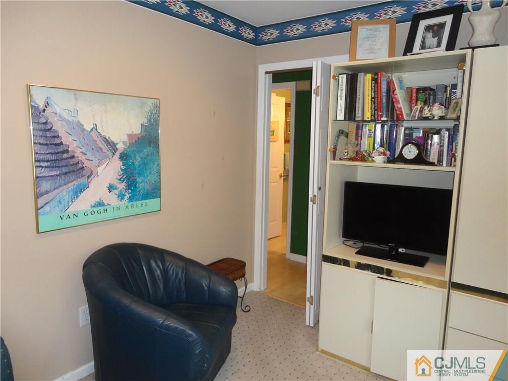 29 Winthrop Road Monroe Township, NJ 08831 - Photo 19 of 25 a living room with furniture and a flat screen tv