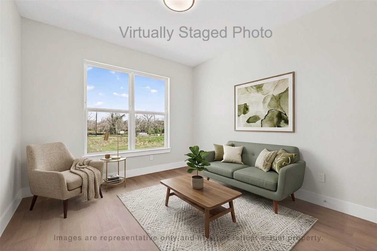 10719 Mason Road, Unit 15 Richmond, TX 77406 - Photo 16 of 50 Virtual Staging - Cozy sitting room featuring a sage green loveseat, a light beige armchair, and a large window offering a scenic outdoor view