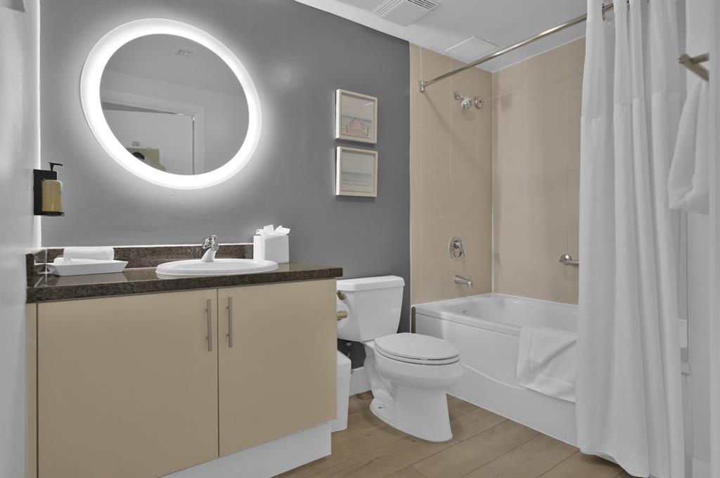 2889 McFarlane Road, Unit 1516 Miami, FL 33133 - Photo 11 of 18 a bathroom with a toilet and a mirror