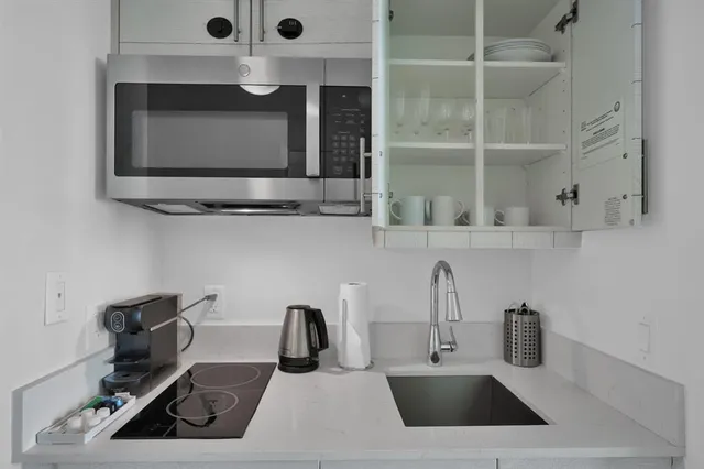 a kitchen with a sink and a microwave