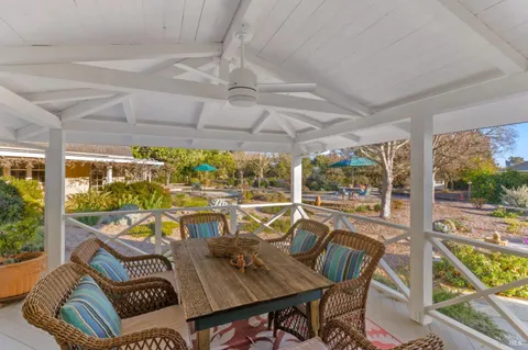 a view of a swimming pool with outdoor seating