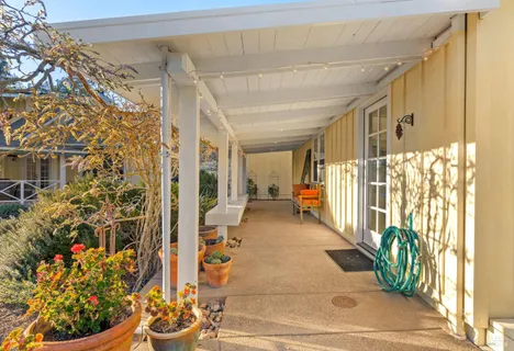 a room with lots of wooden furniture and a refrigerator