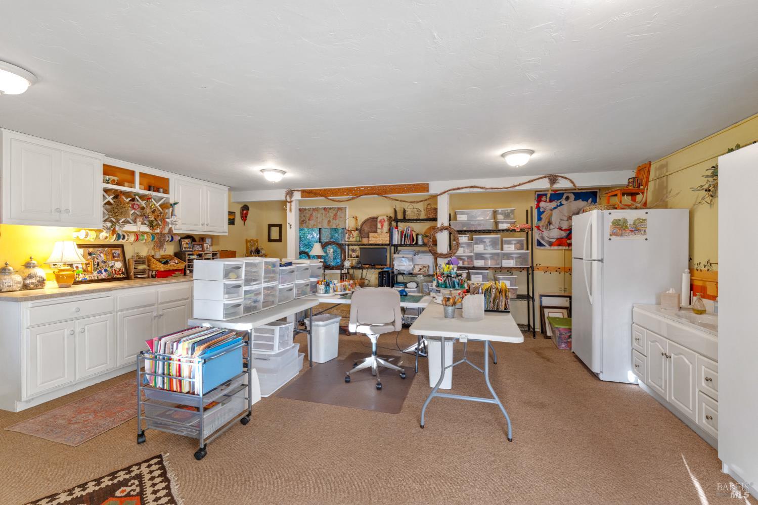 1245 Castle Road Sonoma, CA 95476 - Photo 27 of 48 a room with lots of wooden furniture and a refrigerator