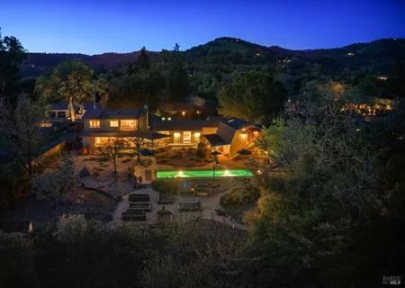 a view of a swimming pool with an outdoor seating and a yard