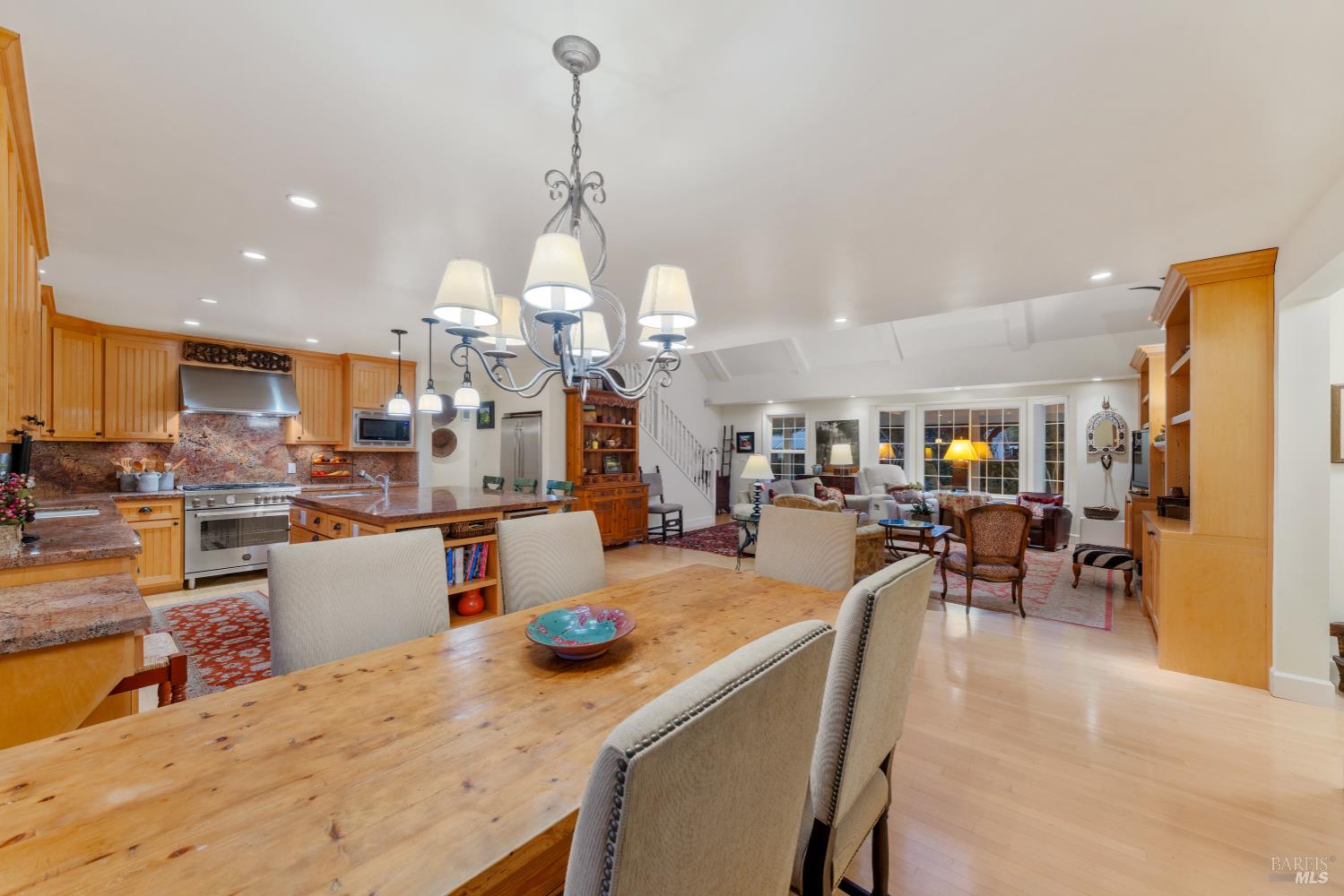 1245 Castle Road Sonoma, CA 95476 - Photo 8 of 48 a kitchen with a dining table wooden floor stainless steel appliances and living room view