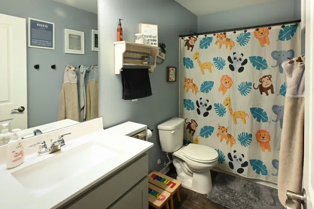 a bedroom with two beds and a potted plant