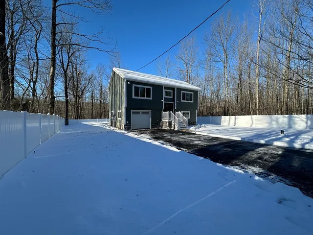 a view of a house with backyard and patio