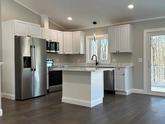 a kitchen with stainless steel appliances a refrigerator sink and microwave