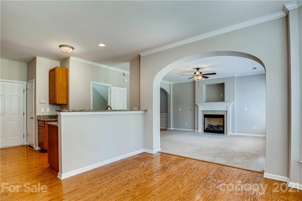 3115 Tanzanite Circle Fort Mill, SC 29708 - Photo 11 of 33 a view of kitchen and empty room with fireplace