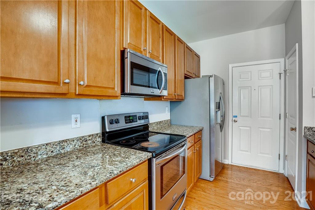 3115 Tanzanite Circle Fort Mill, SC 29708 - Photo 12 of 33 a kitchen with stainless steel appliances granite countertop a refrigerator a stove and a sink