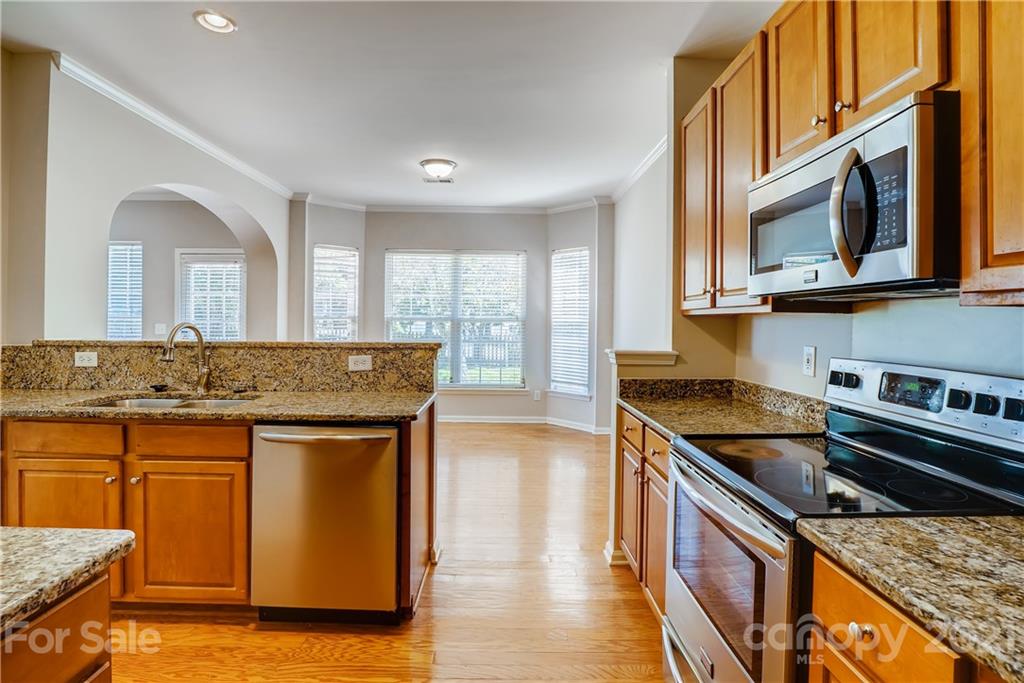 3115 Tanzanite Circle Fort Mill, SC 29708 - Photo 13 of 33 a kitchen with stainless steel appliances granite countertop a sink stove and cabinets