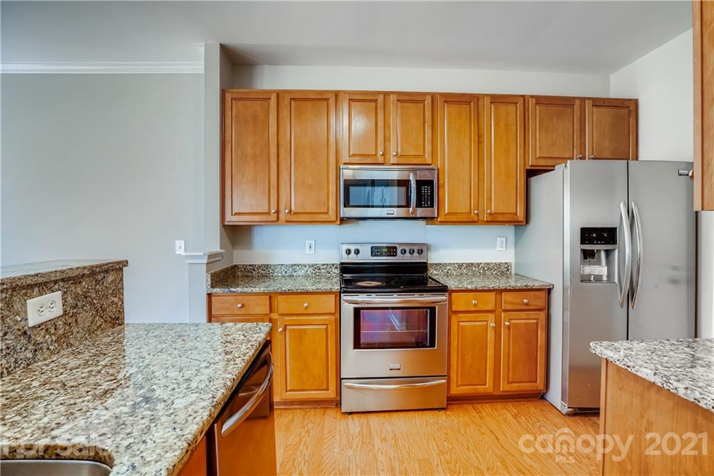 3115 Tanzanite Circle Fort Mill, SC 29708 - Photo 14 of 33 a kitchen with stainless steel appliances granite countertop a stove top oven a refrigerator and a sink