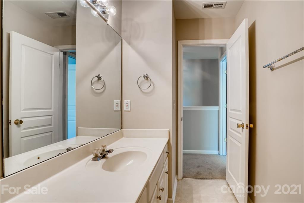 3115 Tanzanite Circle Fort Mill, SC 29708 - Photo 23 of 33 a bathroom with a tub sink and mirror