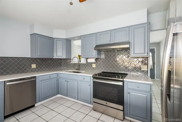 a kitchen with a stove sink and refrigerator