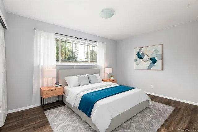 a bedroom with a bed and a painting on the wall