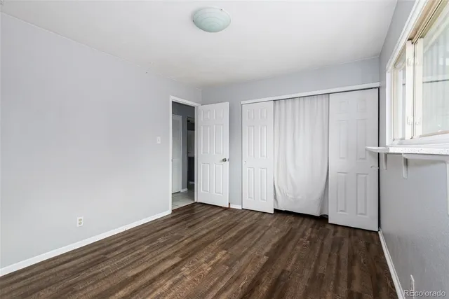 a view of a room with wooden floor and white walls