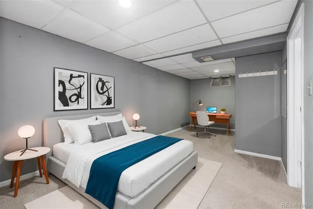 a bed room with a bed and a painting on the wall