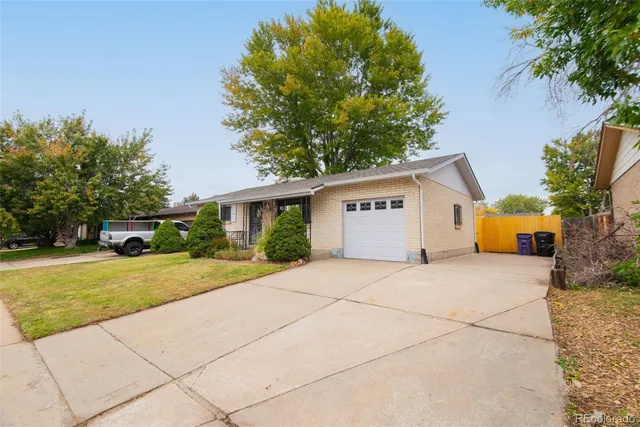 a front view of house with yard and trees