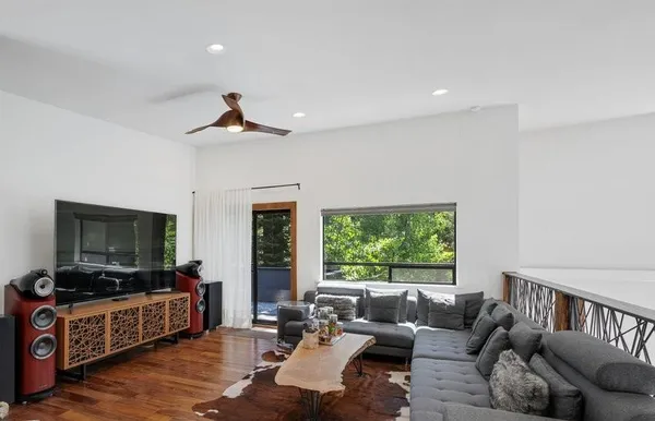 a view of a dining room with furniture a rug and wooden floor