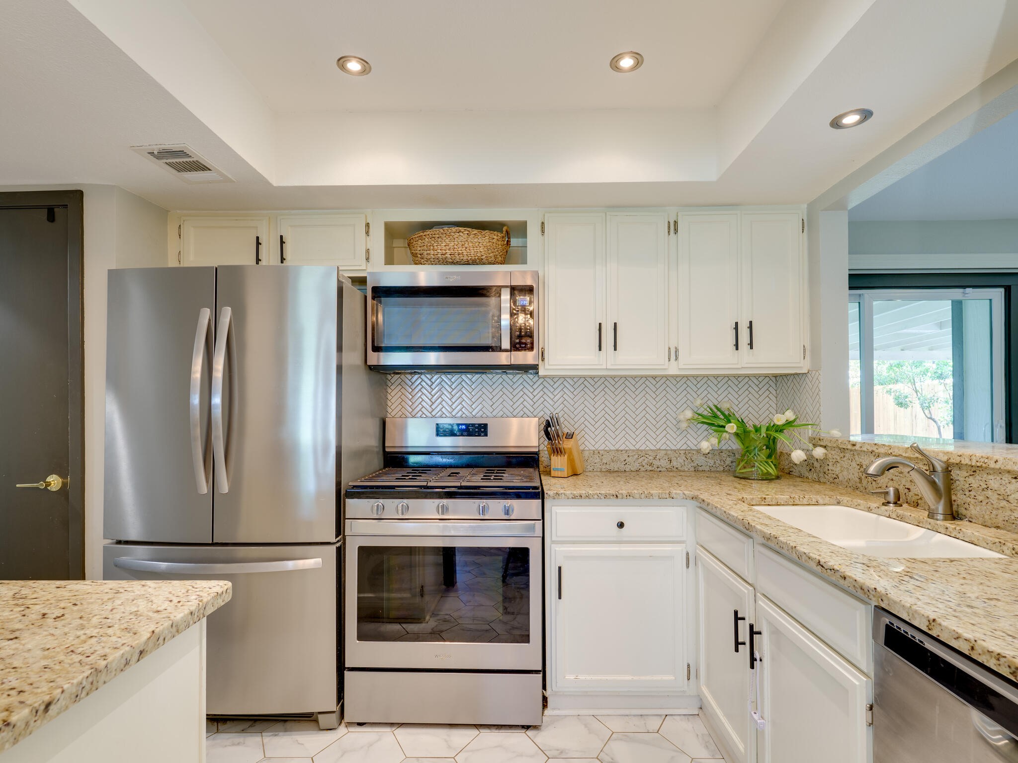 3203 Foster Lane Austin, TX 78757 - Photo 11 of 37 Beautiful kitchen with granite counters is open to the main living space and overlooks the family room.