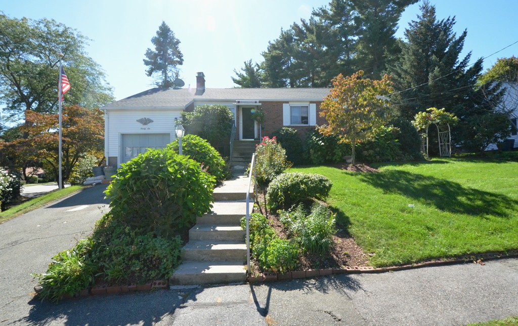 96 Doty Street Waltham, MA 02452 - Photo 12 of 15 a front view of a house with a yard and potted plants
