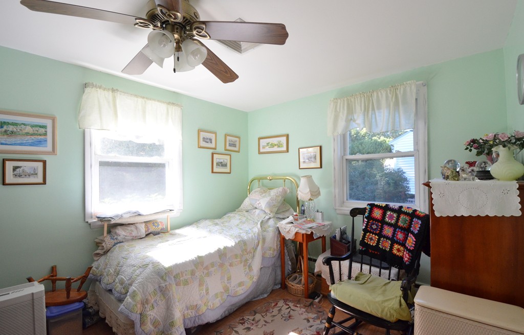 96 Doty Street Waltham, MA 02452 - Photo 9 of 15 a bed room with a bed and a chair