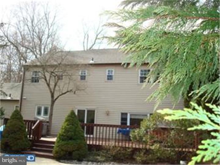 927 Hunt Road Radnor, PA 19008 - Photo 4 of 23 front view of a house with a garden