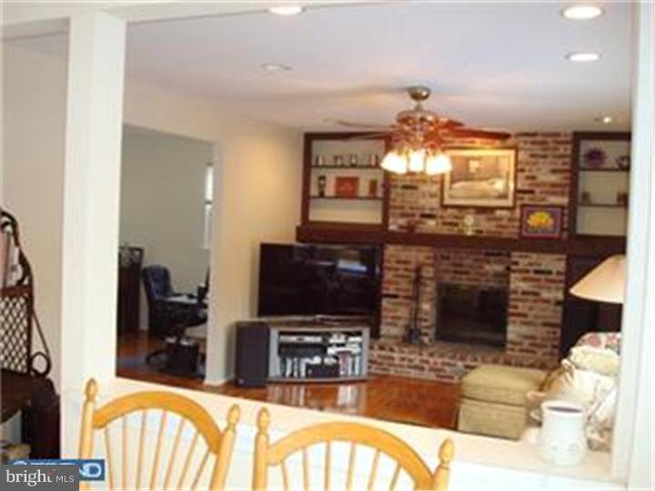 927 Hunt Road Radnor, PA 19008 - Photo 8 of 23 a living room with fireplace furniture and a flat screen tv