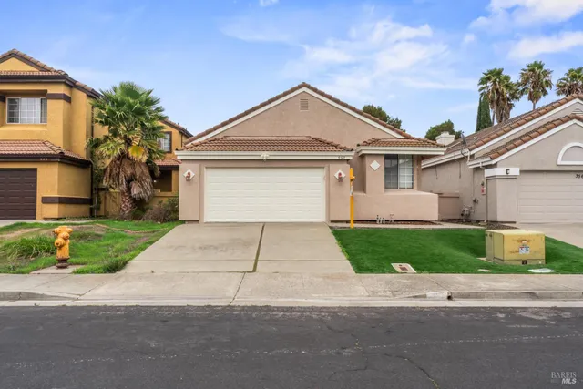 a front view of a house with a yard and a garage