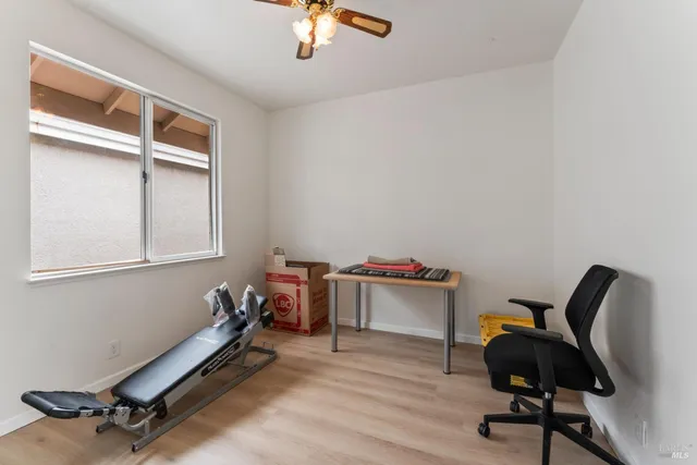 a bedroom with a bed a dresser and a chandelier
